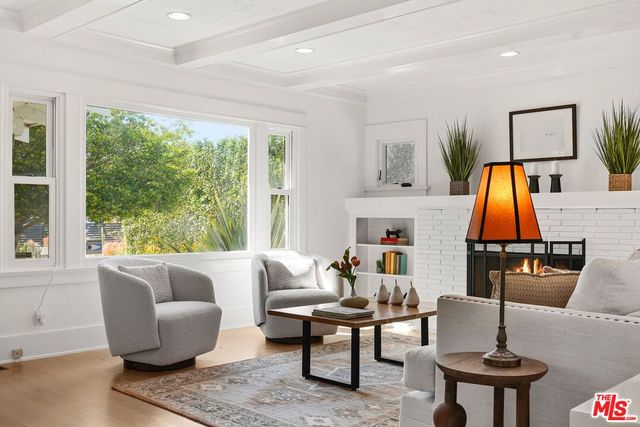a living room with furniture a rug and a large window