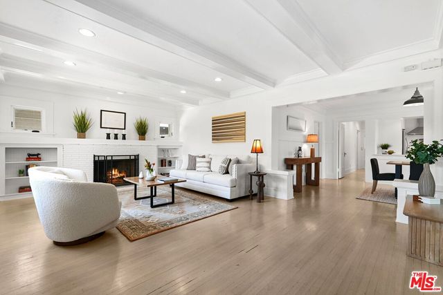 a living room with furniture a fireplace and a table