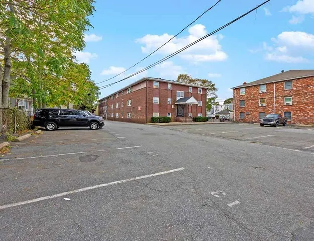 a view of a cars parked on the side of a street