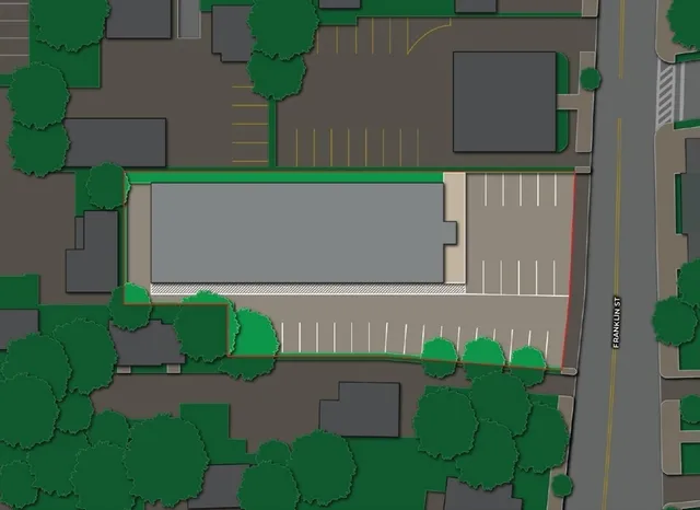 a green field with trees in the background