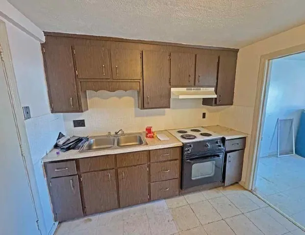 a kitchen with a sink and cabinets