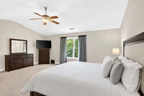a bedroom with a bed and ceiling fan