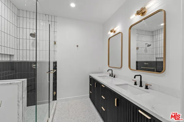 a bathroom with a double vanity sink mirror and double