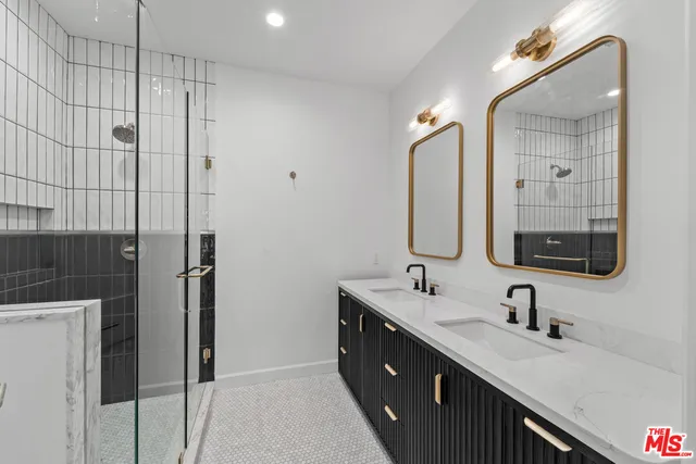 a bathroom with a double vanity sink mirror and double
