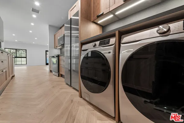 a view of a hallway with washer and dryer