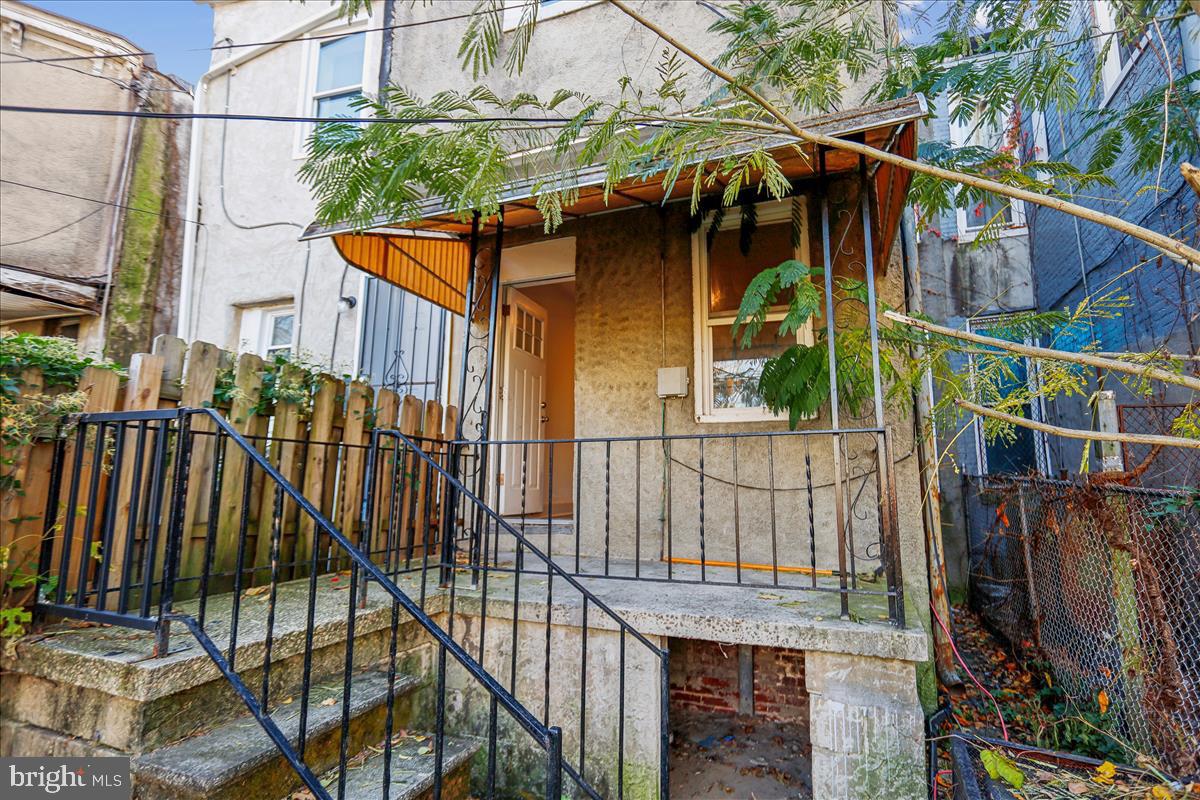 2023 Division Street Baltimore, MD 21217 - Photo 11 of 35 a view of a house with a small yard and wooden fence