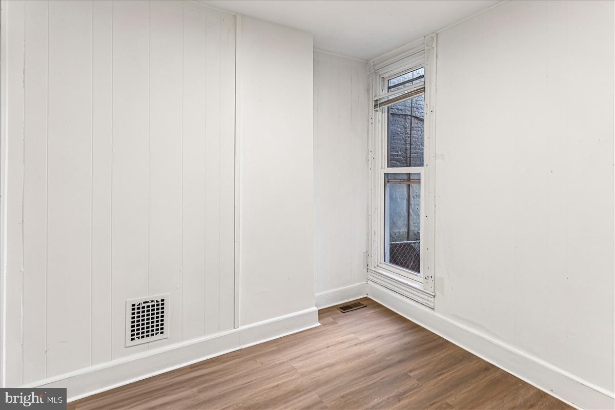 2023 Division Street Baltimore, MD 21217 - Photo 12 of 35 a view of an empty room with wooden floor and closet