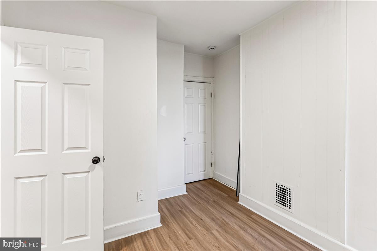 2023 Division Street Baltimore, MD 21217 - Photo 13 of 35 a view of a hallway with wooden floor and closet