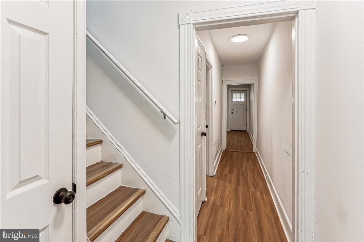 2023 Division Street Baltimore, MD 21217 - Photo 17 of 35 a view of a hallway with wooden floor and staircase