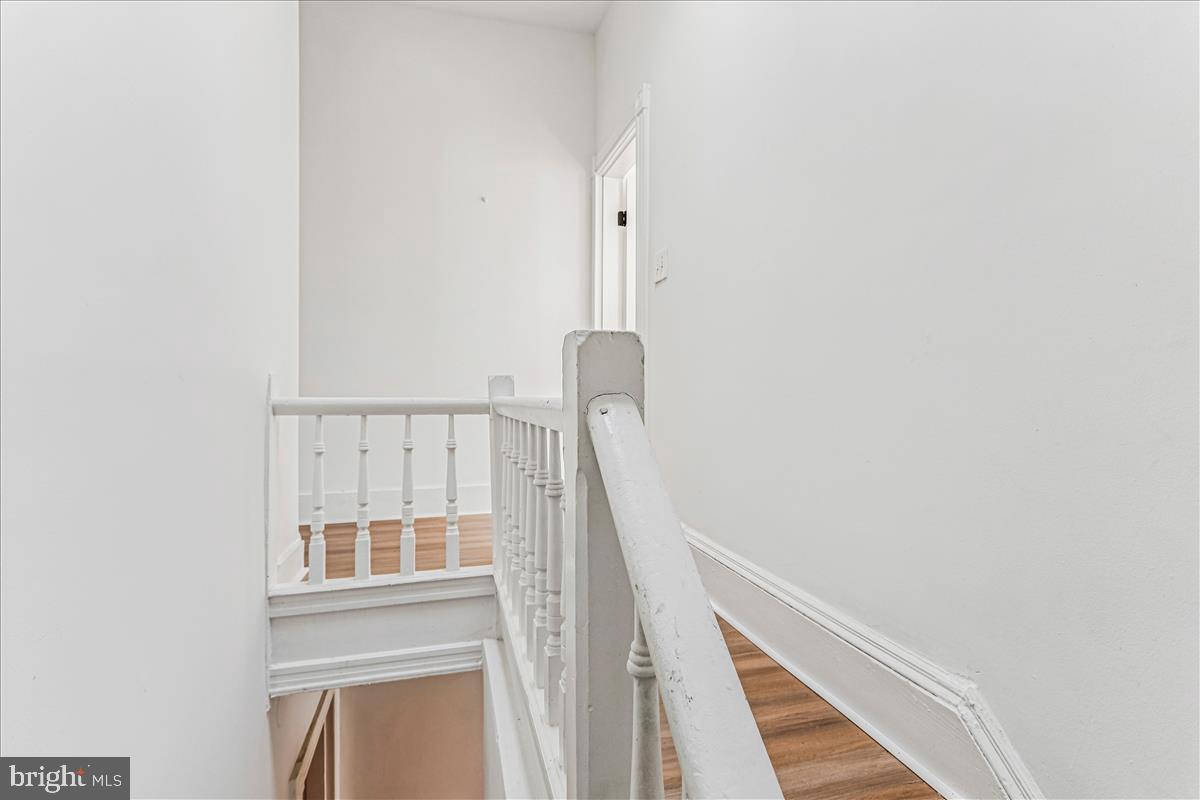 2023 Division Street Baltimore, MD 21217 - Photo 18 of 35 a view of staircase with white walls and a window