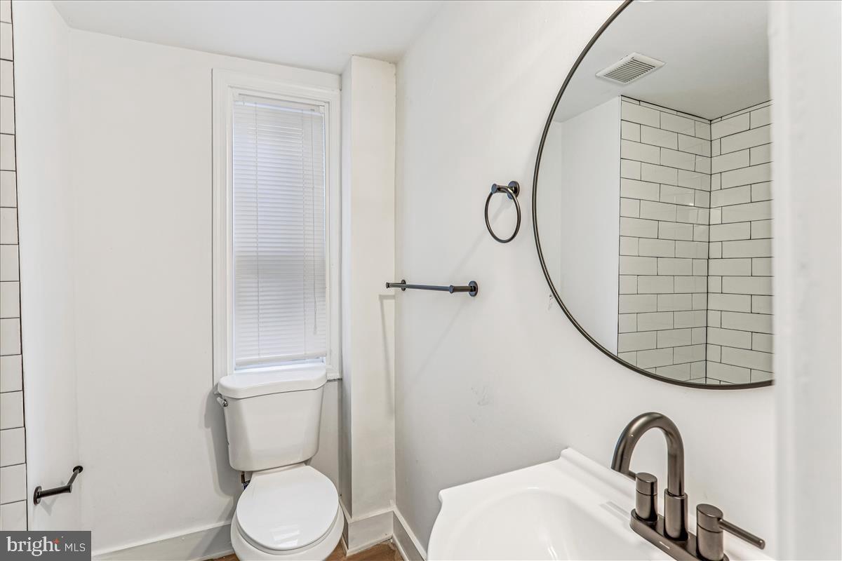 2023 Division Street Baltimore, MD 21217 - Photo 27 of 35 a bathroom with a toilet and a sink