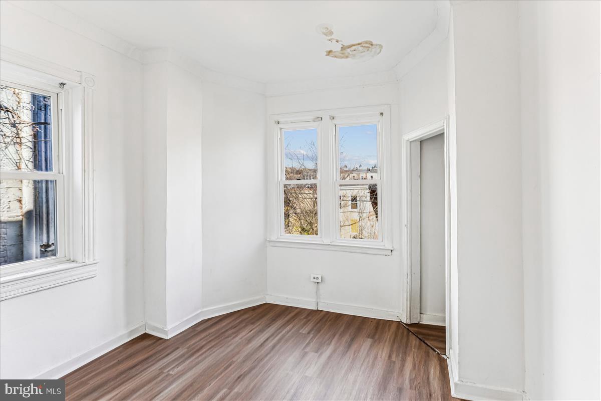 2023 Division Street Baltimore, MD 21217 - Photo 29 of 35 an empty room with wooden floor and windows