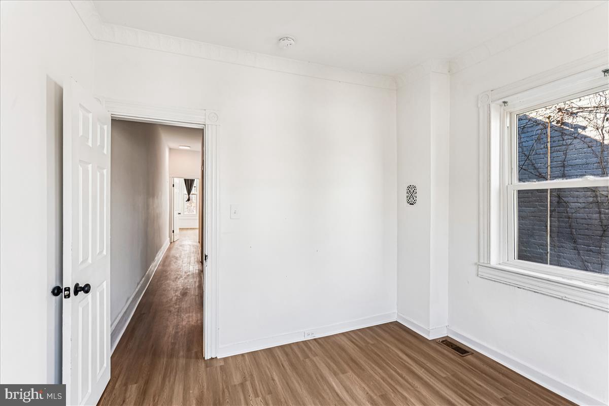 2023 Division Street Baltimore, MD 21217 - Photo 30 of 35 a view of a hallway with wooden floor and a window