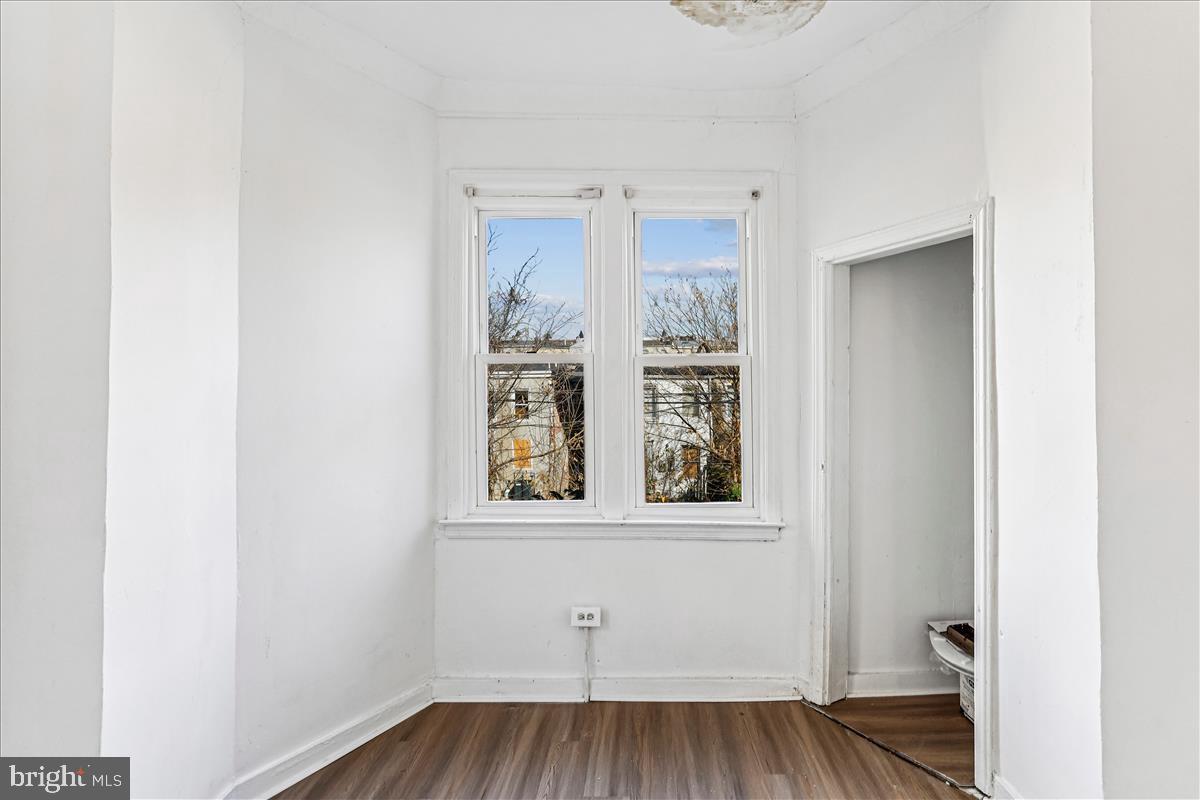 2023 Division Street Baltimore, MD 21217 - Photo 32 of 35 a view of an empty room with wooden floor and a window