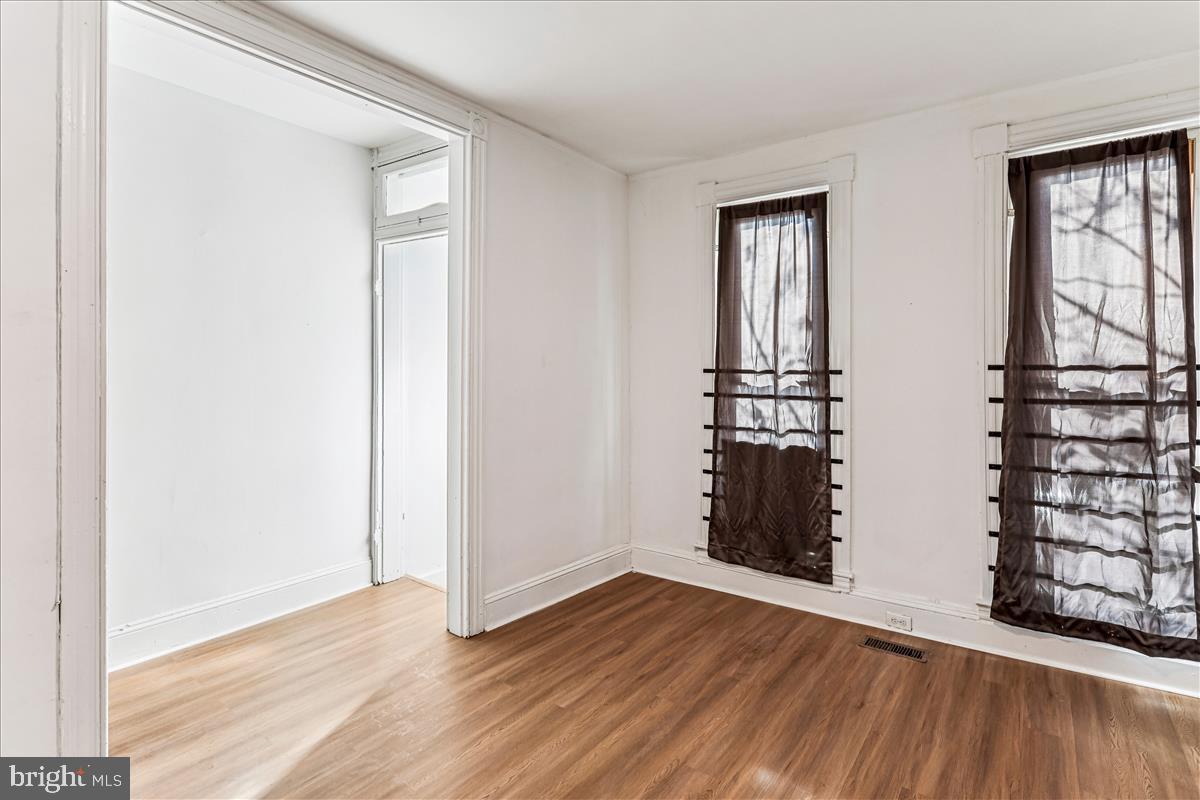 2023 Division Street Baltimore, MD 21217 - Photo 5 of 35 a view of empty room with wooden floor and window