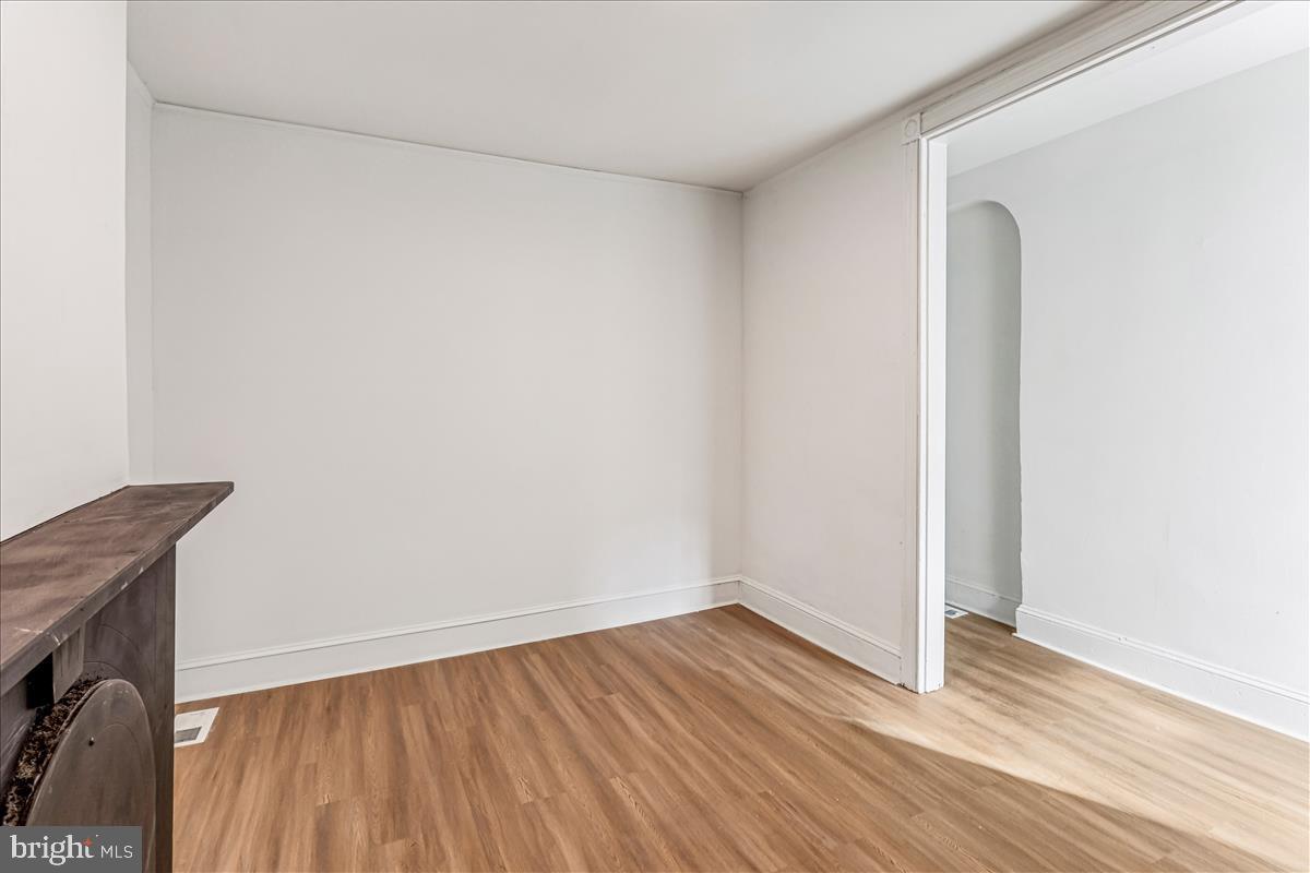 2023 Division Street Baltimore, MD 21217 - Photo 6 of 35 a view of empty room with wooden floor and fan