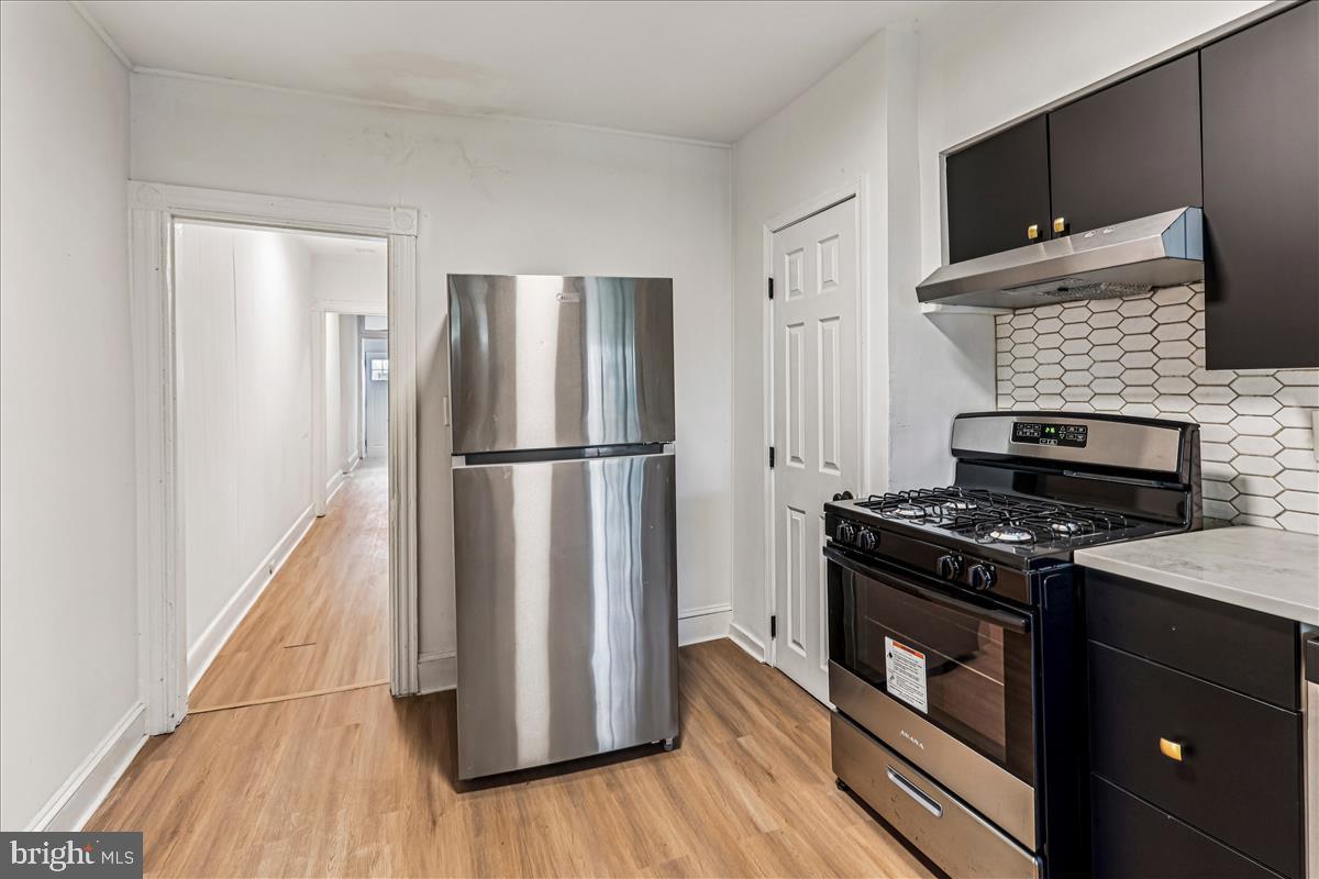 2023 Division Street Baltimore, MD 21217 - Photo 8 of 35 a kitchen with a stove microwave and refrigerator