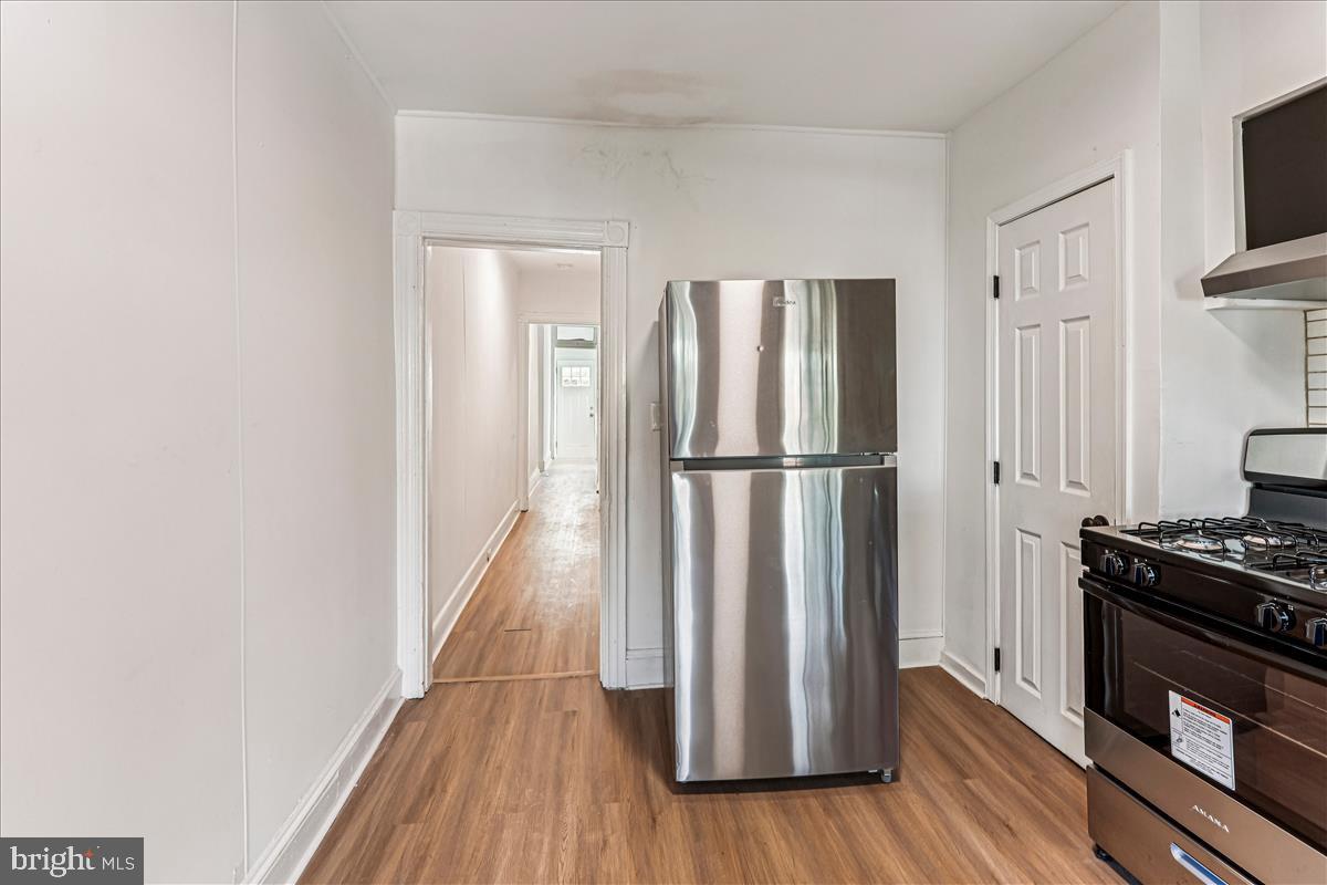 2023 Division Street Baltimore, MD 21217 - Photo 9 of 35 a view of a kitchen with wooden floor and a refrigerator