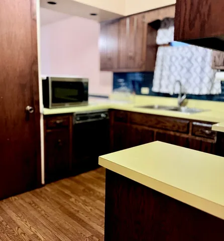 a kitchen with stainless steel appliances a sink a stove a microwave and cabinets