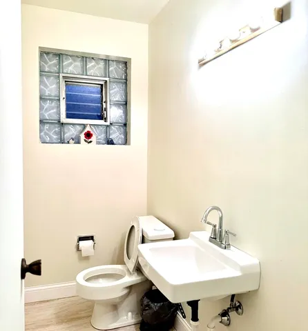 a bathroom with a sink a toilet and mirror