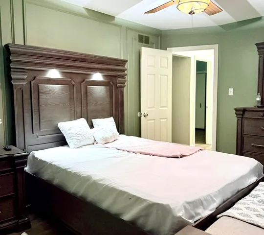 a bedroom with a bed and a mirror