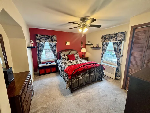 a bedroom with a bed and a mirror