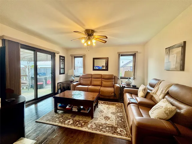 a living room with furniture ceiling fan and a rug