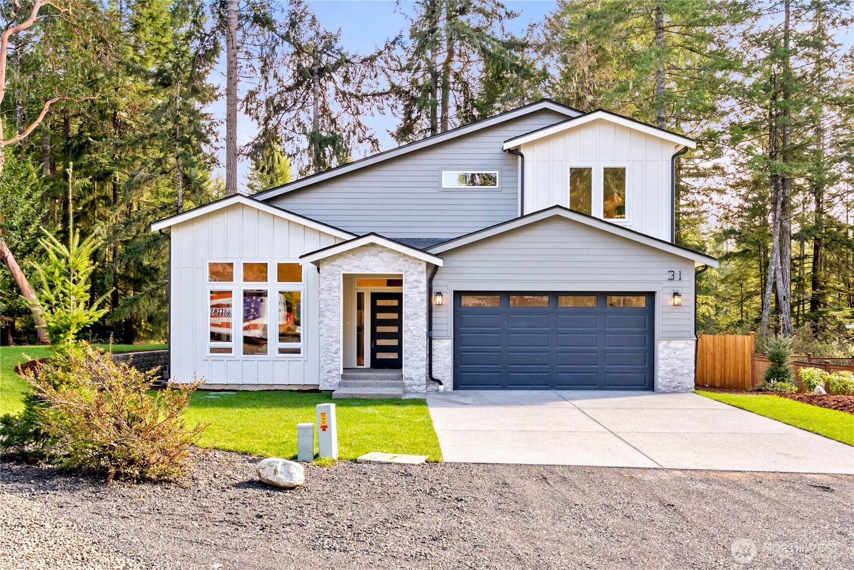 31 East Rhododendron Court Union, WA 98592 - Photo 1 of 38 a front view of a house with a yard and garage