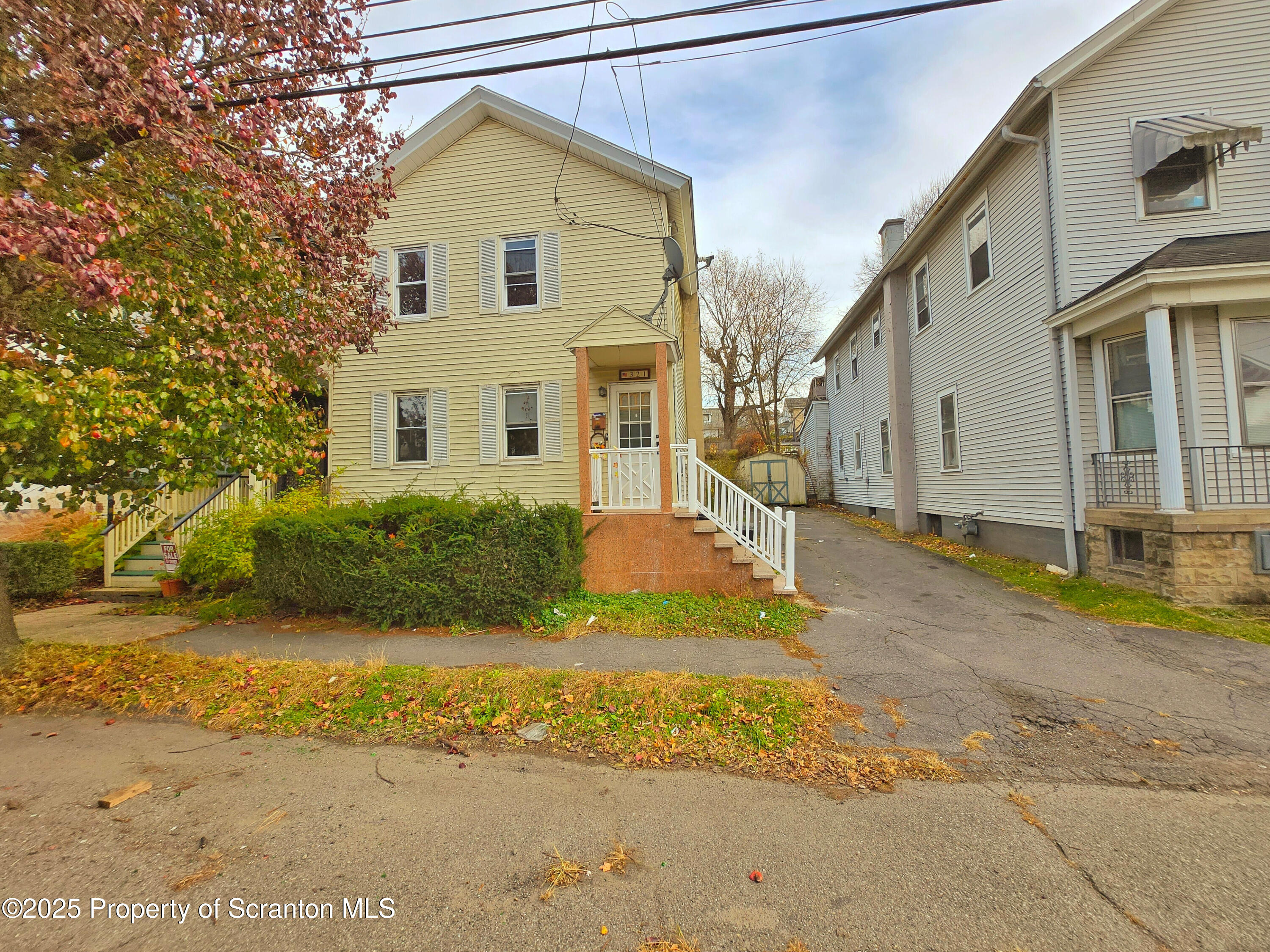 321 Prospect Avenue Scranton, PA 18505 - Photo 1 of 21 a view of a white house next to a yard with big trees