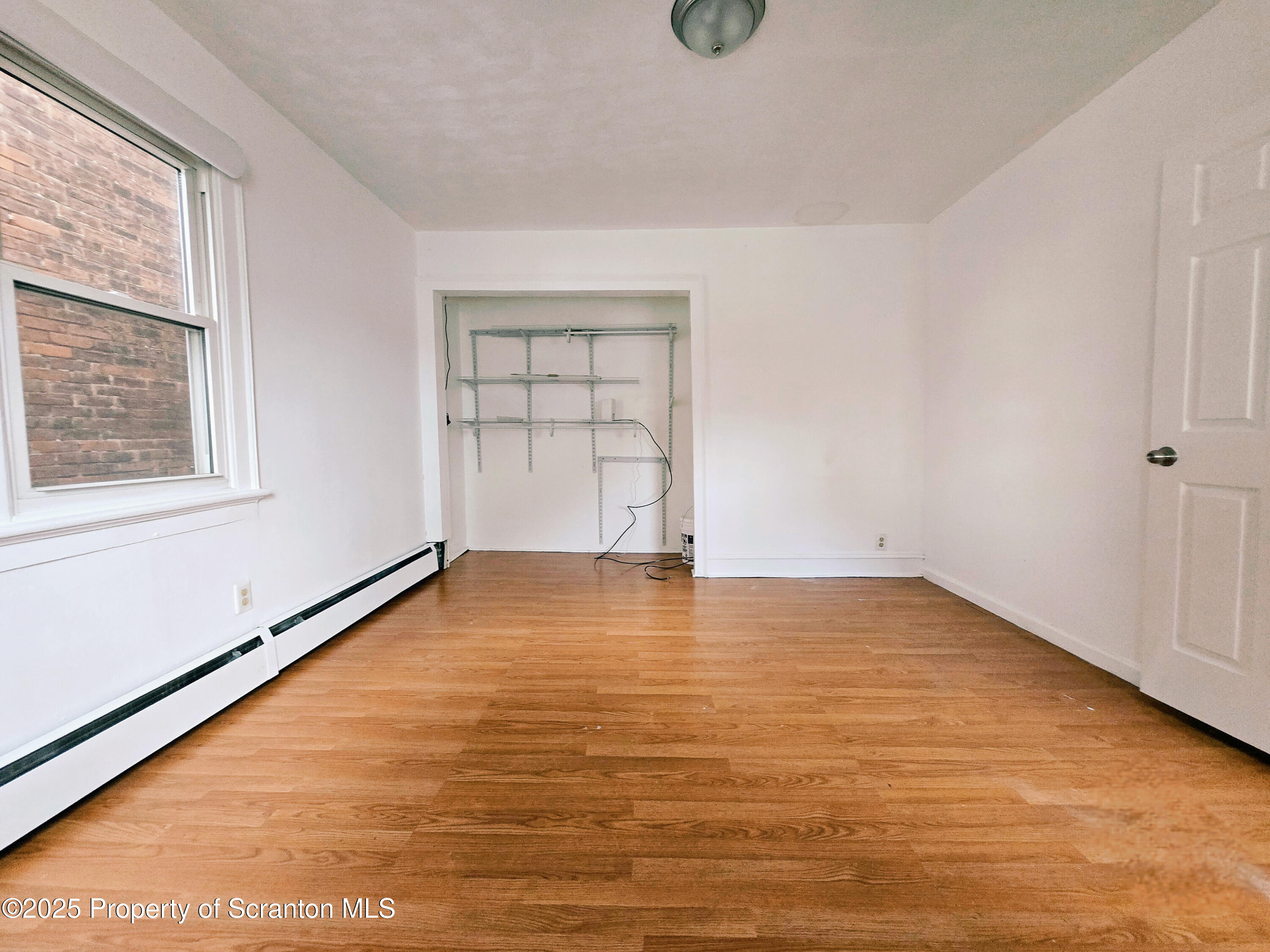 321 Prospect Avenue Scranton, PA 18505 - Photo 12 of 21 an empty room with wooden floor and windows