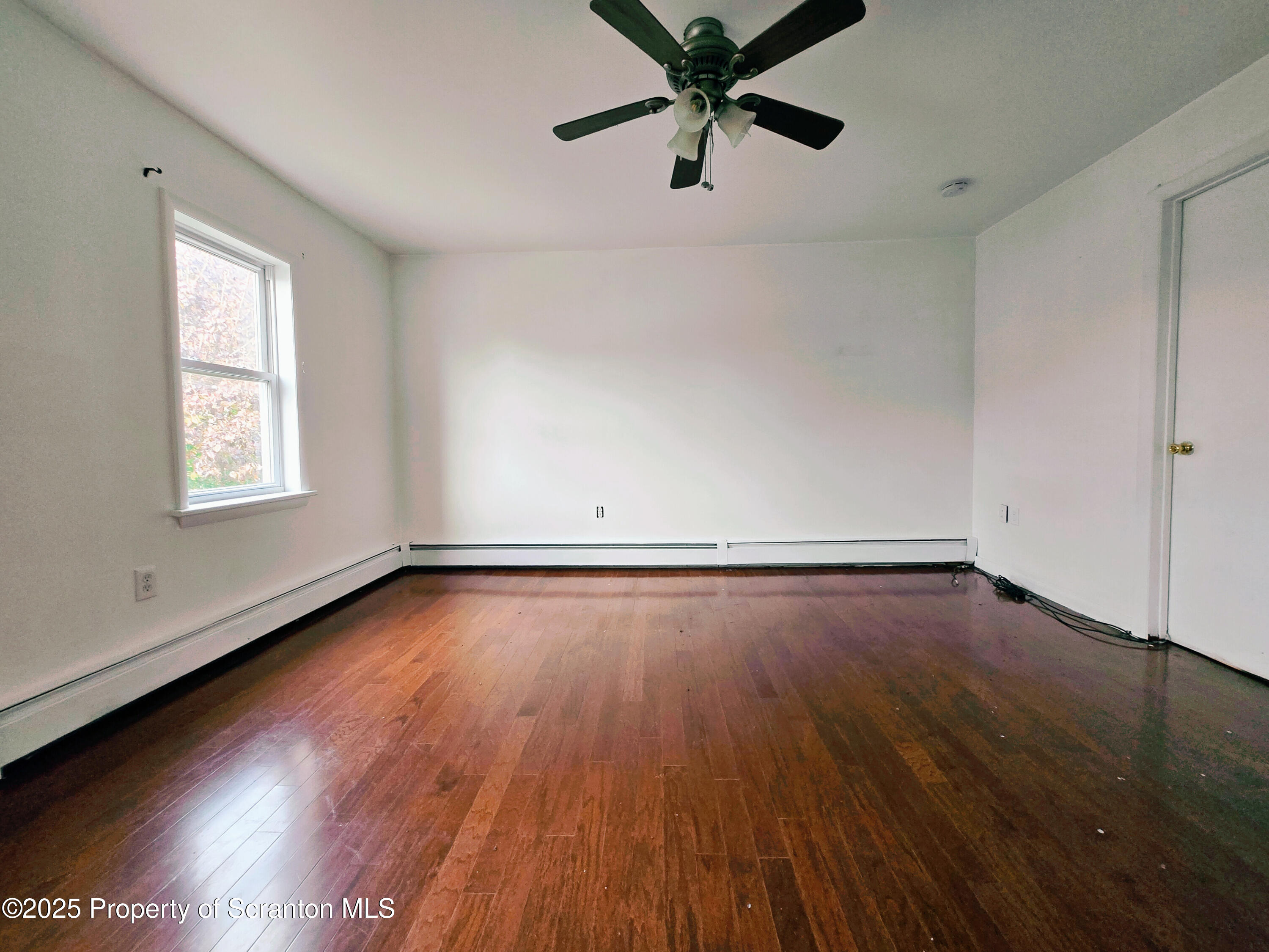 321 Prospect Avenue Scranton, PA 18505 - Photo 14 of 21 an empty room with wooden floor and windows