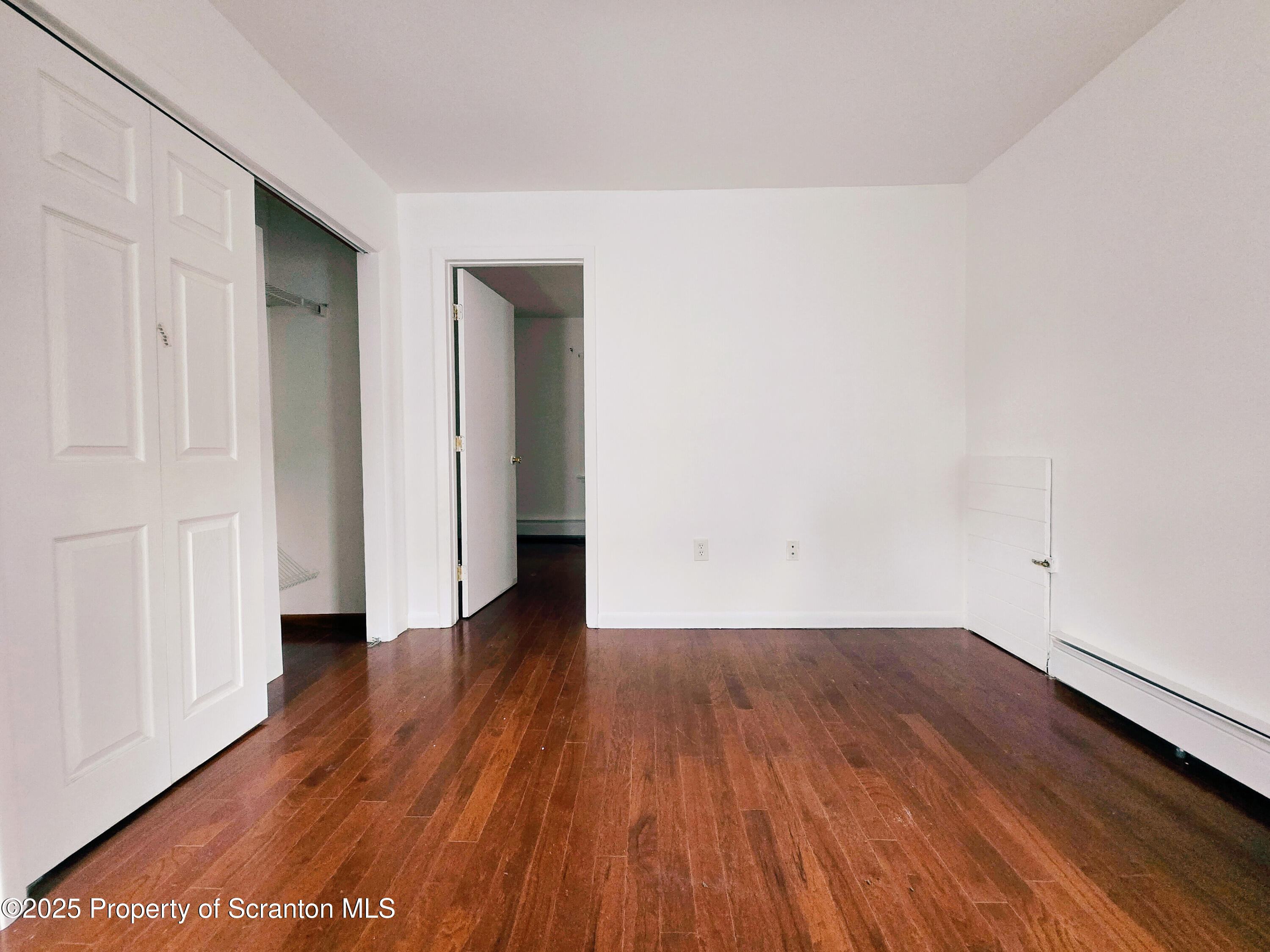 321 Prospect Avenue Scranton, PA 18505 - Photo 17 of 21 a view of a room with wooden floor and white doors