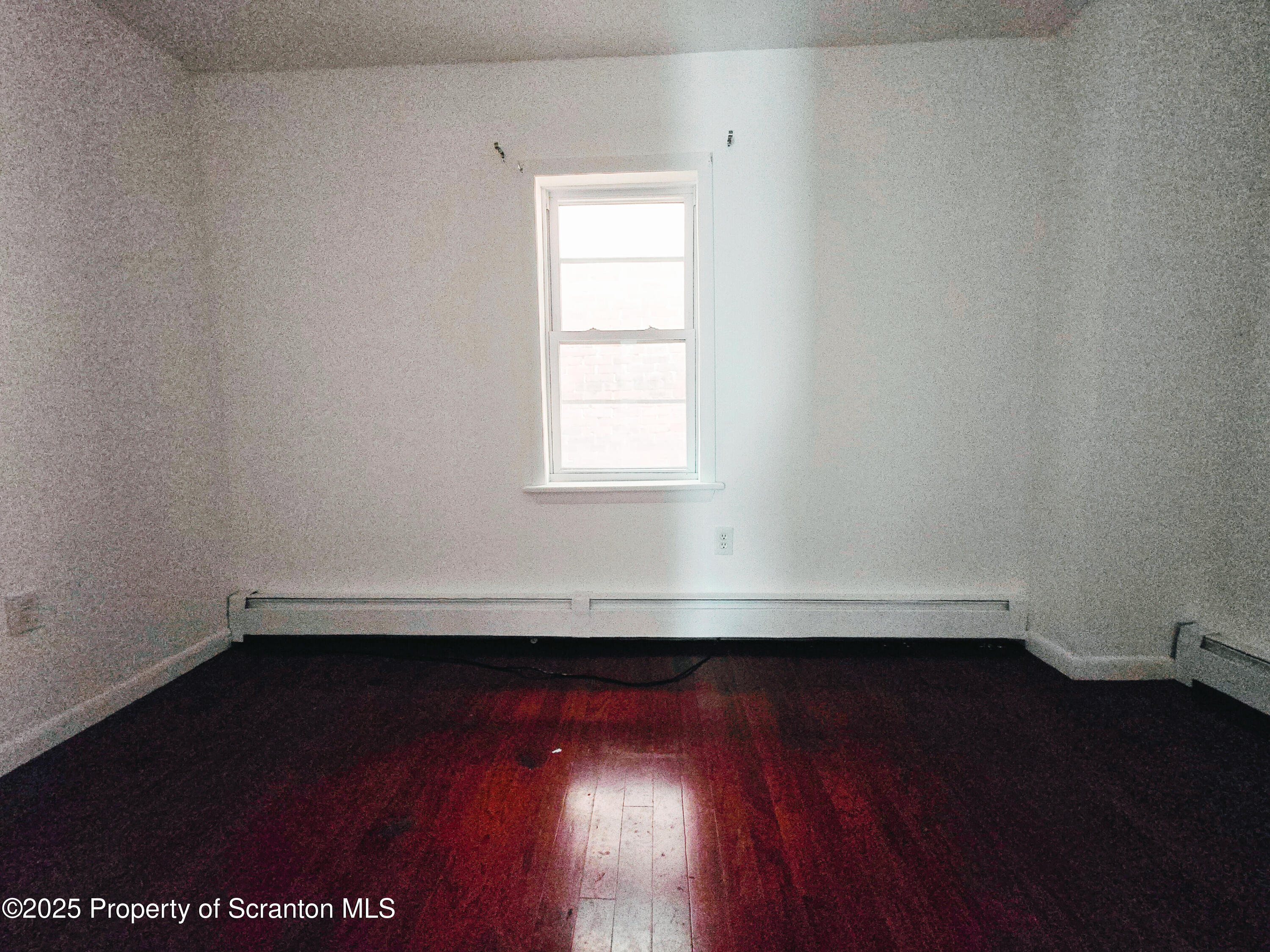 321 Prospect Avenue Scranton, PA 18505 - Photo 18 of 21 an empty room with wooden floor and fan