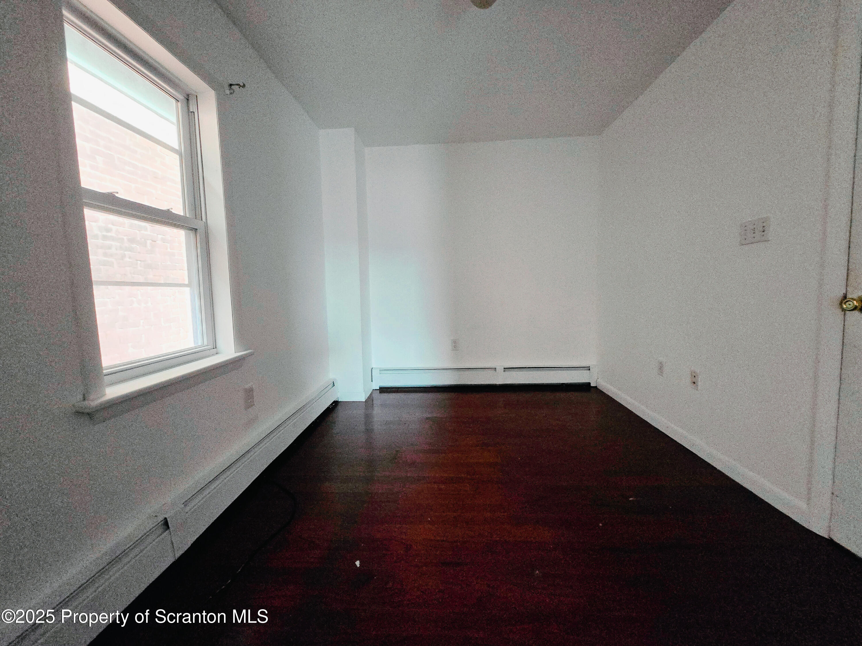 321 Prospect Avenue Scranton, PA 18505 - Photo 19 of 21 an empty room with wooden floor and windows