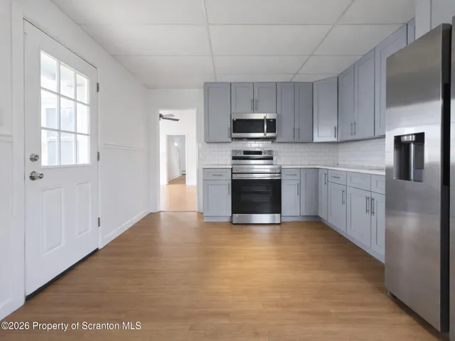 a kitchen with stainless steel appliances granite countertop a stove a sink and a refrigerator