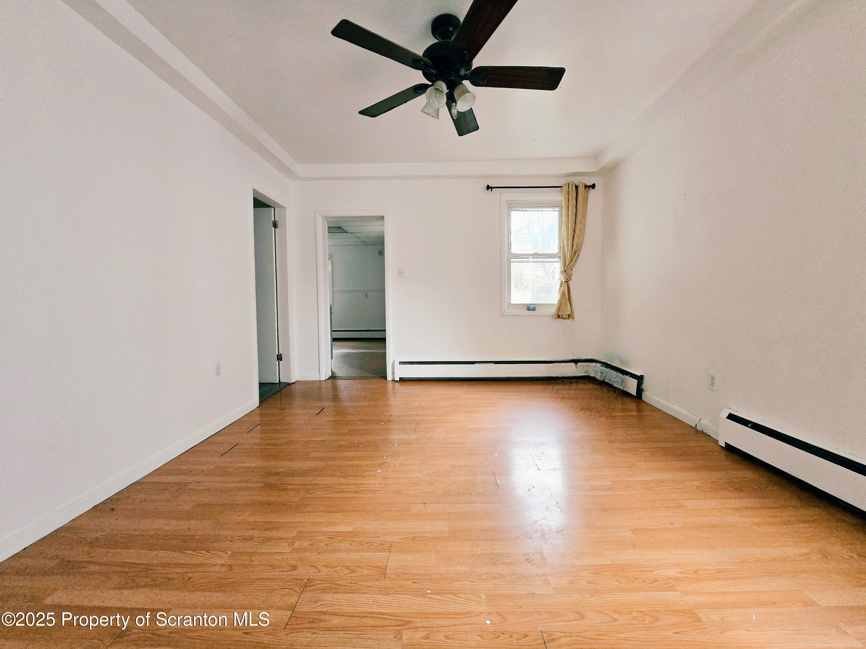 321 Prospect Avenue Scranton, PA 18505 - Photo 8 of 21 an empty room with wooden floor and windows