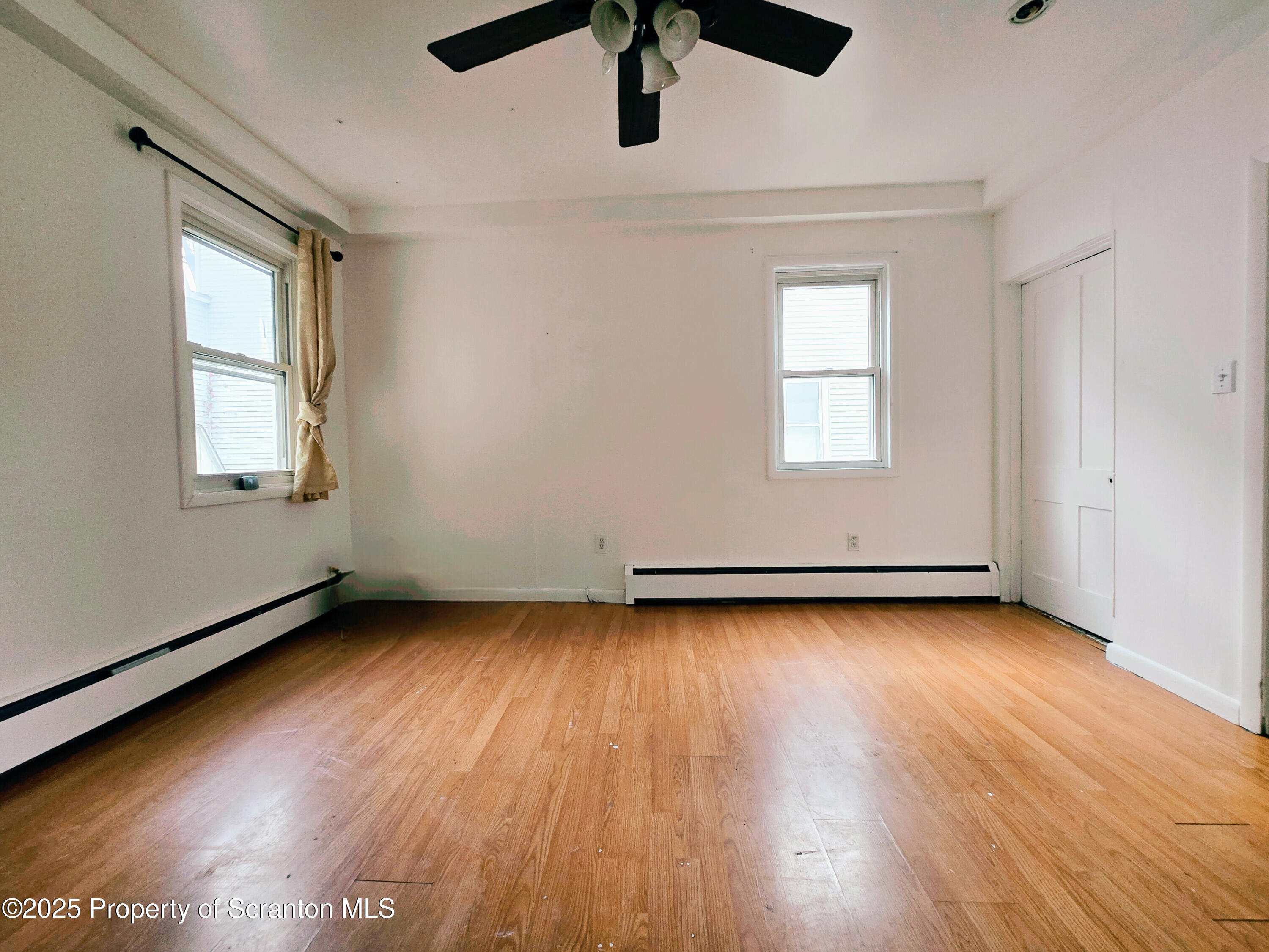 321 Prospect Avenue Scranton, PA 18505 - Photo 9 of 21 an empty room with wooden floor and windows