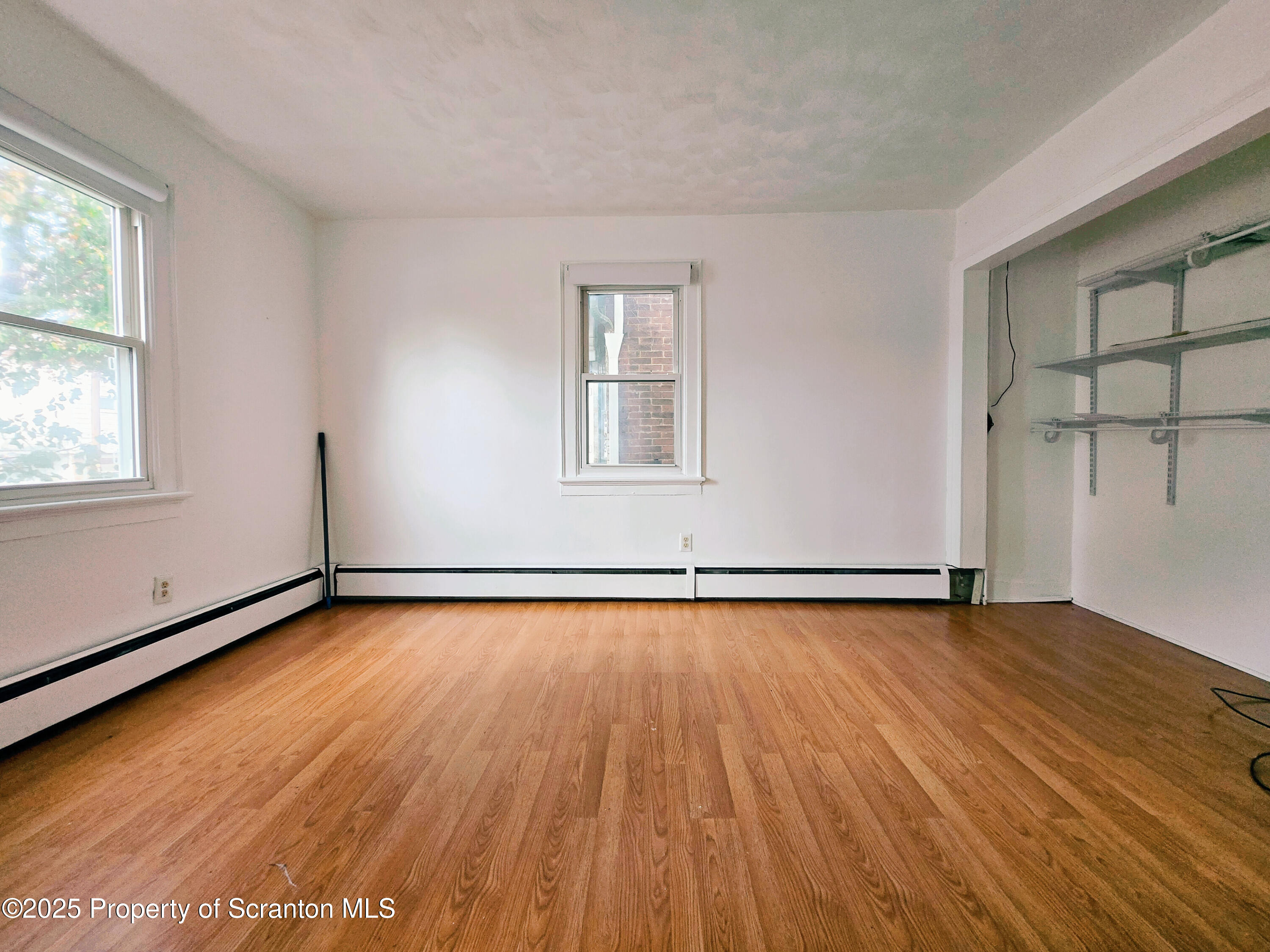 321 Prospect Avenue Scranton, PA 18505 - Photo 10 of 21 an empty room with wooden floor and windows