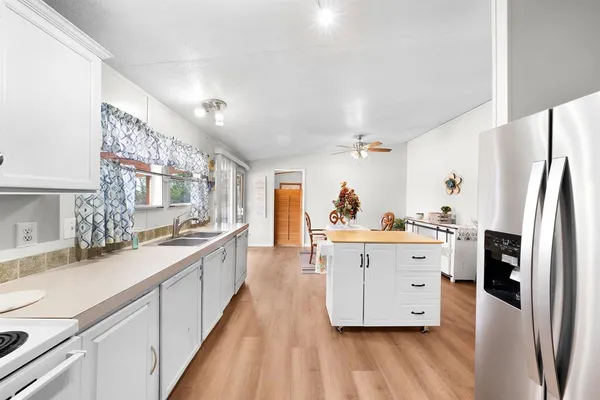 a large kitchen with cabinets and stainless steel appliances