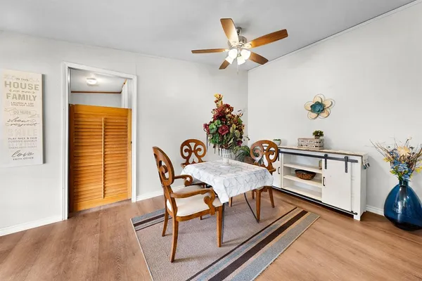 a view of a dining room with furniture and wooden floor
