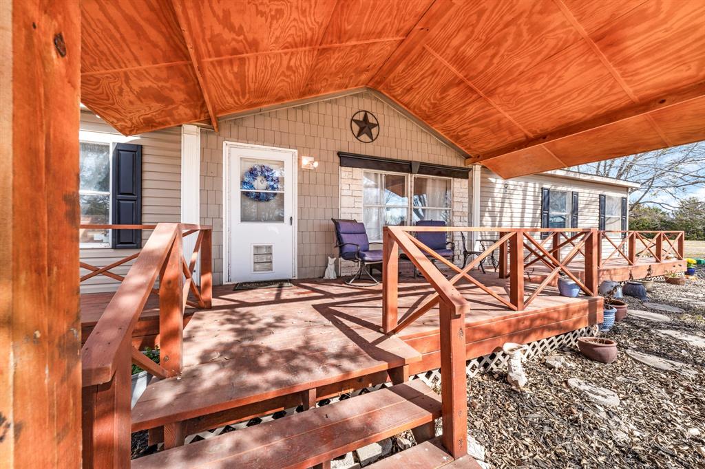 366 Tony Lane Fate, TX 75189 - Photo 6 of 36 a view of a patio with table and chairs with wooden floor and fence