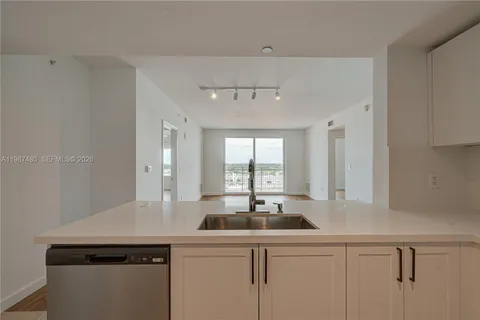 a view of washer and dryer with bathroom in the background