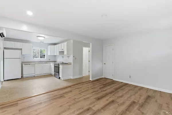 a view of a kitchen with white cabinets