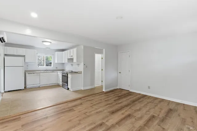 a view of a kitchen with white cabinets