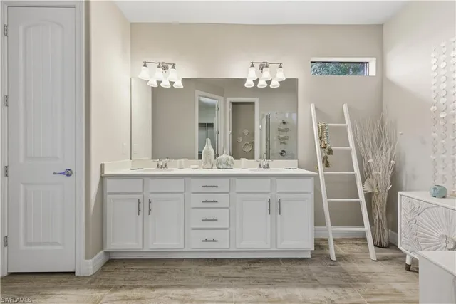 a bathroom with a double vanity sink and a mirror