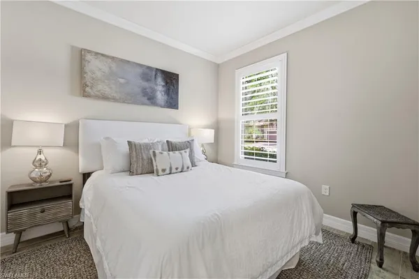 a bedroom with a bed and a lamp with window