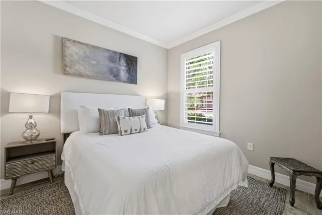 a bedroom with a bed and a lamp with window