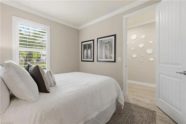 a bedroom with a bed a closet and a window