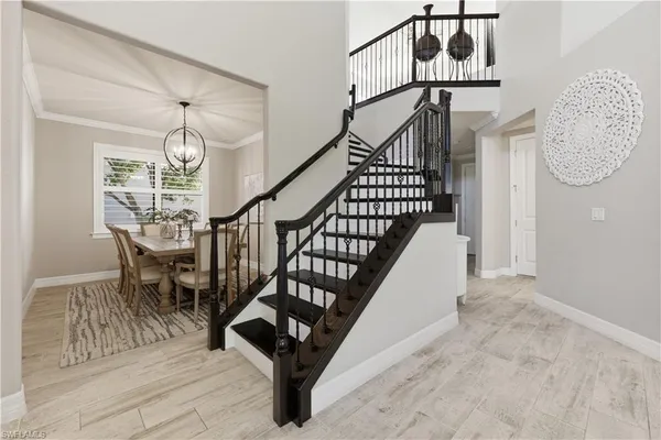 a view of entryway dining room and hall with wooden floor