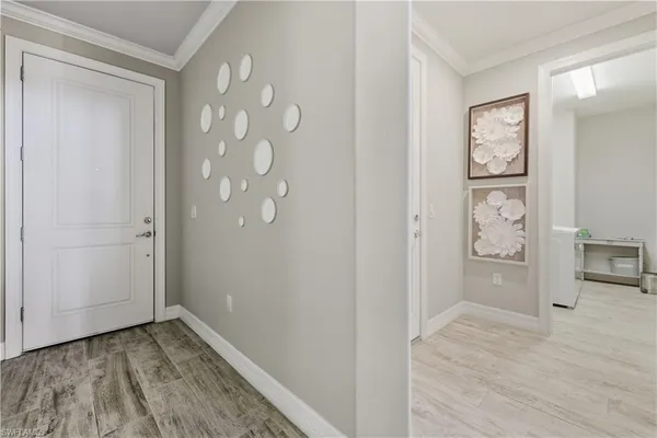 a view of a hallway with wooden floor and closet